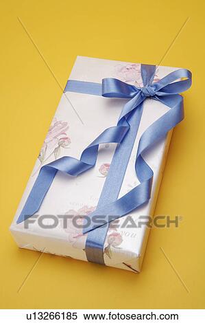 Close-up of a wrapped present with blue ribbon View Large Photo Image Stock Photography - Close-up of a wrapped present with blue ribbon. Fotosearch