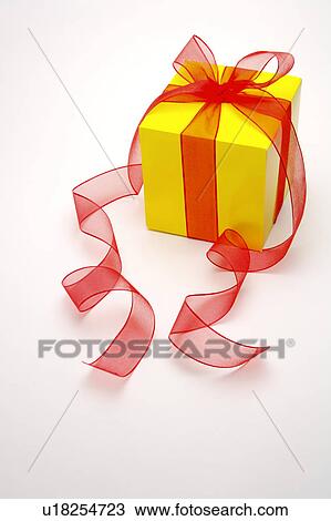Close-up of a wrapped present with red ribbon View Large Photo Image Stock Image - Close-up of a wrapped present with red ribbon. Fotosearch