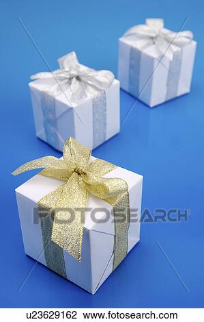 Close-up of three wrapped presents View Large Photo Image Stock Image - Close-up of three wrapped presents. Fotosearch