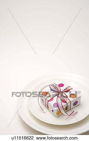 Close-up of wrapped gift on the plate View Large Photo Image Stock Image - Close-up of wrapped gift on the plate. Fotosearch