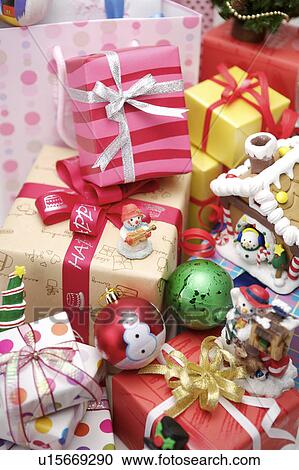 Stock Image - Close-up of wrapped presents and Christmas decoration. Fotosearch