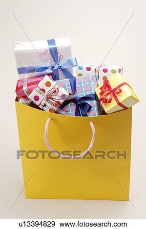 Close-up of wrapped presents in the shopping bag View Large Photo Image Stock Photo - Close-up of wrapped presents in the shopping bag. Fotosearch