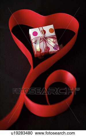 Wrapped gift in the heart shape ribbon View Large Photo Image Stock Image - Wrapped gift in the heart shape ribbon. Fotosearch
