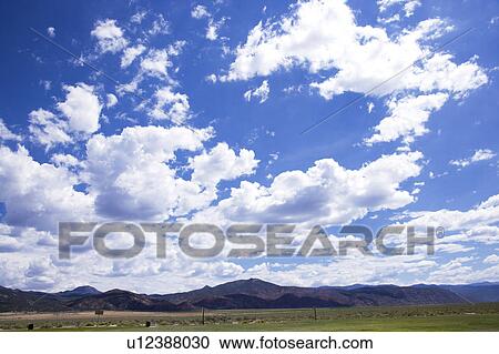 Stock Image - Clouds in the clear sky. Fotosearch