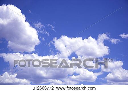 Stock Image - Clouds in the clear sky. Fotosearch