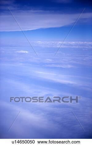 Stock Image - Clouds in the clear sky. Fotosearch