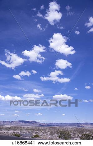 Stock Image - Clouds in the clear sky. Fotosearch