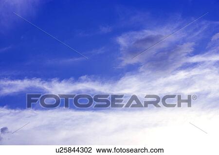 Stock Image - Clouds in the clear sky. Fotosearch
