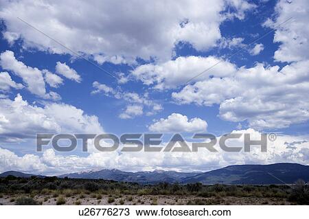 Stock Image - Clouds in the clear sky. Fotosearch