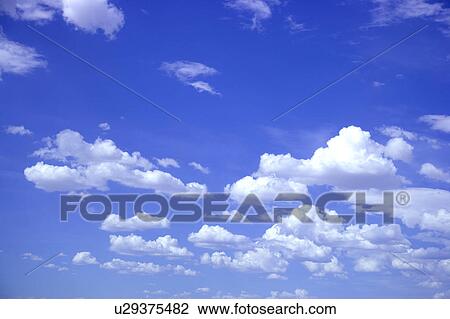 Stock Image - Clouds in the clear sky. Fotosearch