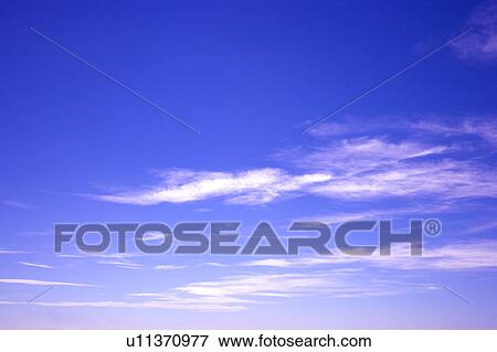 Stock Photo - Clouds in the clear sky. Fotosearch