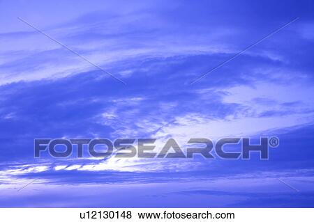 Stock Photo - Clouds in the clear sky. Fotosearch