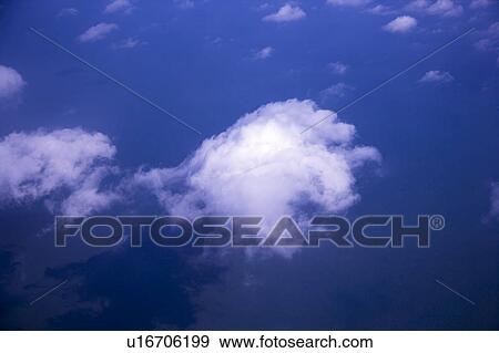 Stock Photo - Clouds in the clear sky. Fotosearch