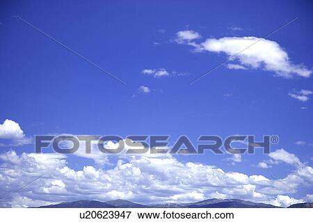 Stock Photo - Clouds in the clear sky. Fotosearch