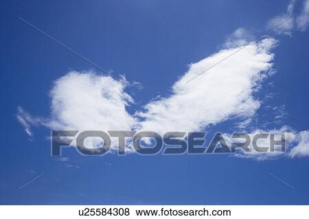 Stock Photo - Clouds in the clear sky. Fotosearch