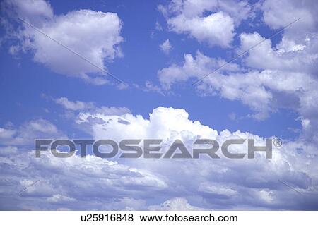 Stock Photo - Clouds in the clear sky. Fotosearch