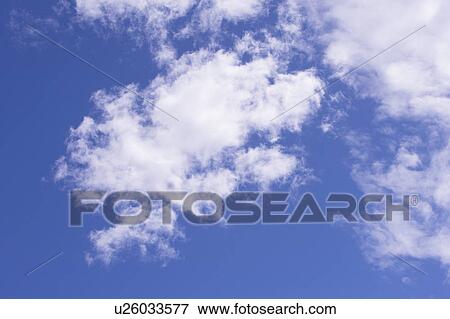 Stock Photo - Clouds in the clear sky. Fotosearch