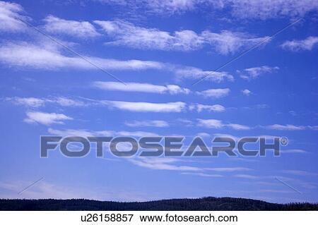 Stock Photo - Clouds in the clear sky. Fotosearch