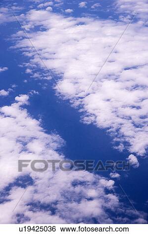 Clouds in the clear sky View Large Photo Image Stock Photograph - Clouds in the clear sky. Fotosearch