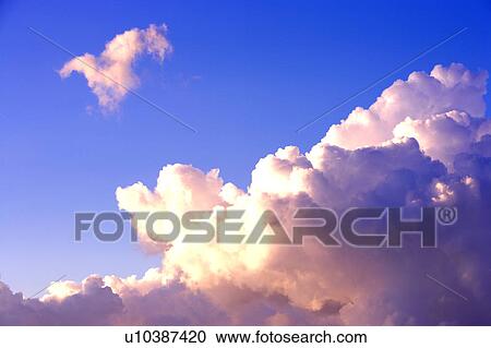 Stock Image - Cumulus clouds in the clear sky. Fotosearch