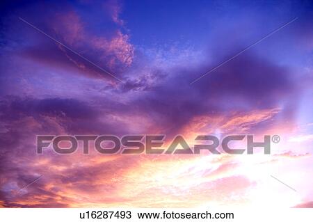 Stock Image - Pink clouds in the clear sky. Fotosearch