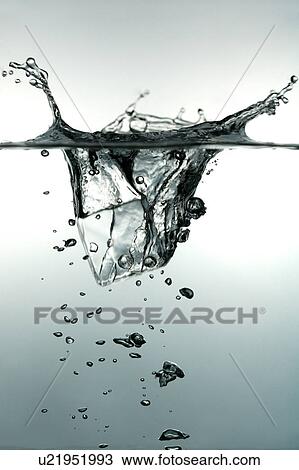 Stock Image - An ice cube dropping into the water. Fotosearch