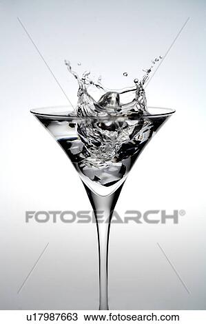 Stock Image - Close-up of a wineglass of splashing water. Fotosearch