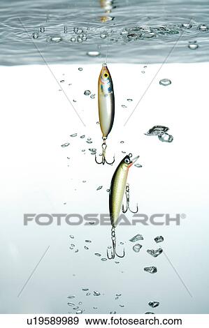 Close-up of two fishing hook in the water View Large Photo Image Stock Photo - Close-up of two fishing hook in the water. Fotosearch