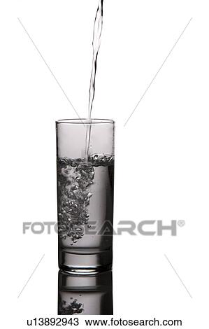 Stock Image - Water pouring into a glass. Fotosearch