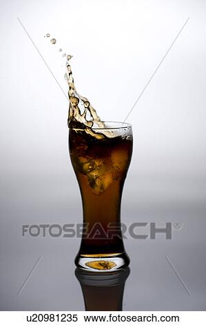 Water splashing from a glass of drink View Large Photo Image Stock Photography - Water splashing from a glass of drink. Fotosearch
