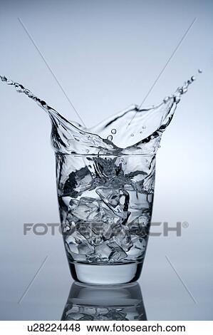 Water splashing from a glass of ice cubes View Large Photo Image Stock Photo - Water splashing from a glass of ice cubes. Fotosearch