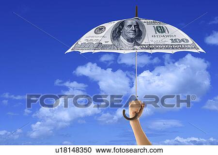 Clipart - A hand holding an umbrella with paper money design. Fotosearch