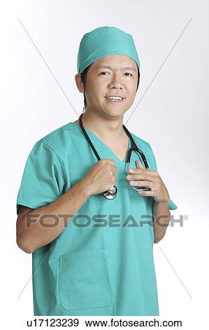 Doctor holding the stethoscope and smiling at the camera View Large Photo Image Stock Photo - Doctor holding the stethoscope and smiling at the camera. Fotosearch