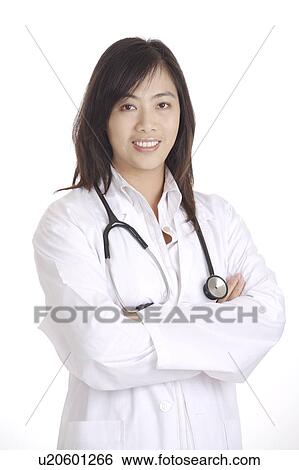 Female doctor looking at the camera with arms crossed View Large Photo Image Stock Photograph - Female doctor looking at the camera with arms crossed. Fotosearch