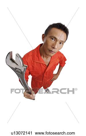 Mechanic holding the screwdriver and looking at the camera View Large Photo Image Stock Image - Mechanic holding the screwdriver and looking at the camera. Fotosearch