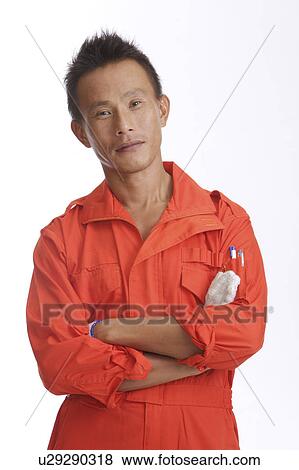 Mechanic standing with hands on chest and smiling at the camera View Large Photo Image Stock Photo - Mechanic standing with hands on chest and smiling at the camera. Fotosearch