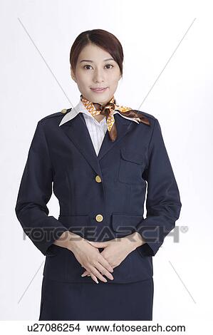 Picture - Portrait of an Asian flight attendant, looking at the camera. Fotosearch