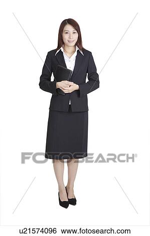 Young business woman holding a notebook and looking at the camera View Large Photo Image Stock Photograph - Young business woman holding a notebook and looking at the camera. Fotosearch