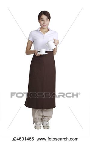 Young waitress holding a teapot and a cup, looking at the camera View Large Photo Image Stock Photography - Young waitress holding a teapot and a cup, looking at the camera. Fotosearch