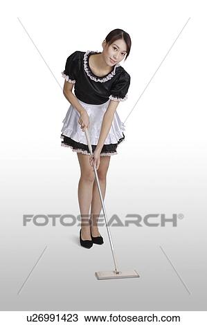Young woman cleaning the floor with a mop, looking at the camera View Large Photo Image Stock Image - Young woman cleaning the floor with a mop, looking at the camera. Fotosearch