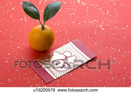 Close-up of a red envelope and an orange View Large Photo Image Stock Photo - Close-up of a red envelope and an orange. Fotosearch