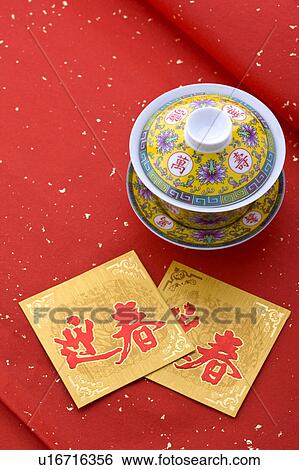 Stock Photograph - Close-up of a tea cup and two cards for celebrating Chinese New Year. Fotosearch