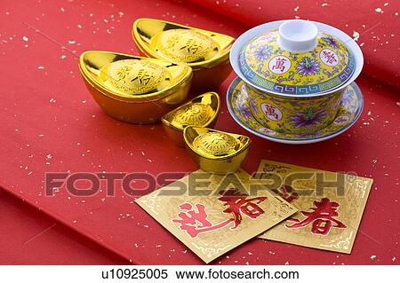 Close-up of a tea cup, gold ingots and two cards of celebrating Chinese New Year View Large Photo Image Stock Photography - Close-up of a tea cup, gold ingots and two cards of celebrating Chinese New Year. Fotosearch