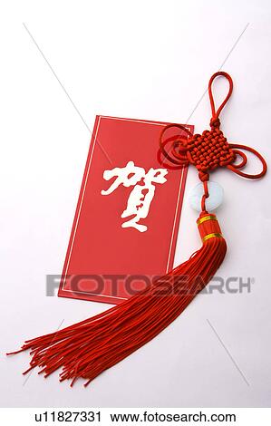 Stock Image - Close-up of a traditional ornament and a Chinese New Year card. Fotosearch
