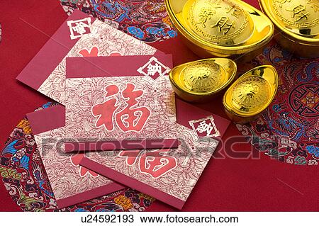 Stock Image - Close-up of gold ingots and cards for blessing. Fotosearch