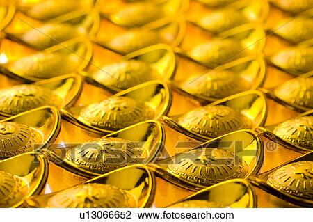 Close-up of gold yuanbao ingots in a row, full frame View Large Photo Image Stock Image - Close-up of gold yuanbao ingots in a row, full frame. Fotosearch