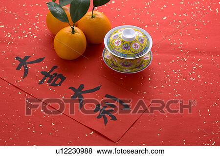 Close-up of three oranges, a tea cup and a Chinese New Year banner View Large Photo Image Stock Photo - Close-up of three oranges, a tea cup and a Chinese New Year banner. Fotosearch