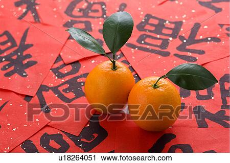 Stock Image - Close-up of two oranges on Chinese script. Fotosearch