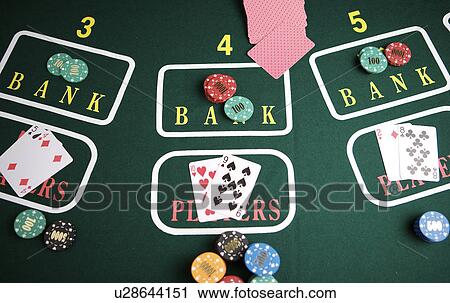 Chips and playing cards on gaming table View Large Photo Image Stock Image - Chips and playing cards on gaming table. Fotosearch