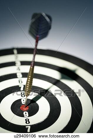 Dart in bull's eye of dart board, close-up View Large Photo Image Stock Photograph - Dart in bull's eye of dart board, close-up. Fotosearch